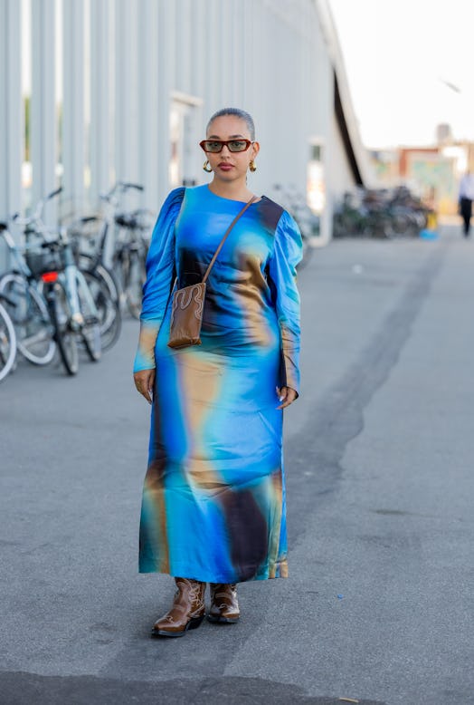 A guest is seen wearing blue dress outside Munthe during Copenhagen Fashion Week