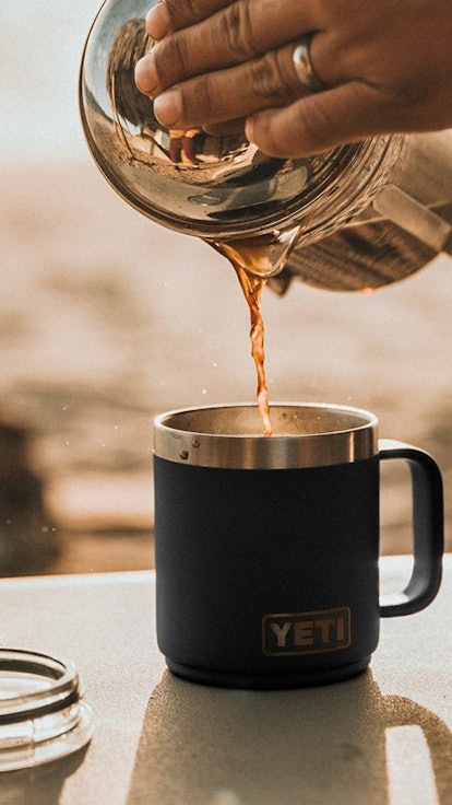 Coffee being poured into a to-go mug