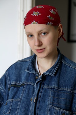 A portrait of a person wearing a red bandana