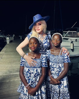 Madonna matching with two of her children in blue-and-white dresses by Dolce & Gabbana