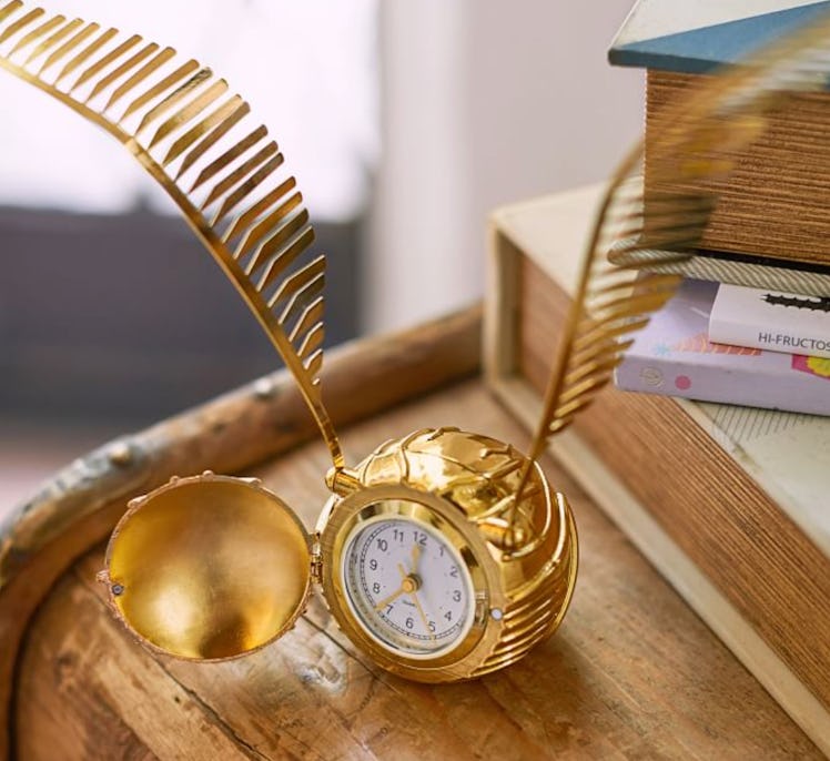 The Golden Snitch Clock is a magical dorm decor piece from Pottery Barn Teen's Harry Potter home col...