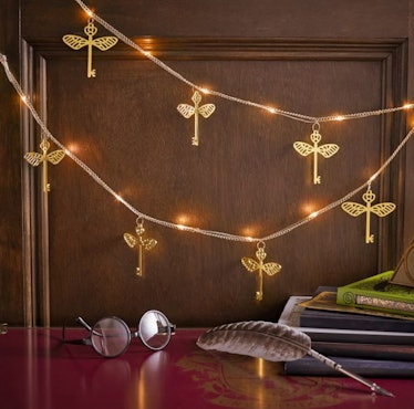 The Winged Key String Lights are a magical dorm decor piece from Pottery Barn Teen's Harry Potter ho...