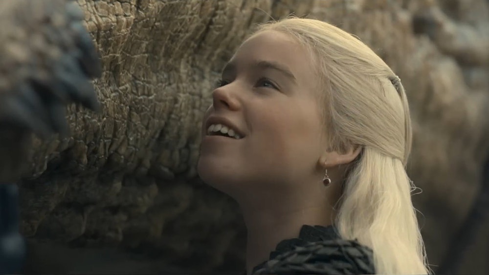 Milly Alcock as Rhaenyra Targaryen, with a dragon.