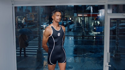 A man posing in Telfars new Olympic-worthy sportswear line wearing black shorts and a shirt
