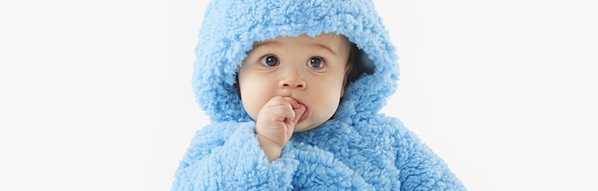 A baby in a blue fuzzy Cookie Monster Halloween costume in an article about Pottery Barn Halloween c...
