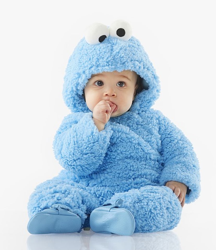 A baby in a blue fuzzy Cookie Monster Halloween costume in an article about Pottery Barn Halloween c...