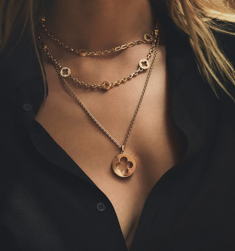 A closeup of a model wearing the Louis Vuitton’s Empreinte Collection necklace 