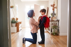 Mother helping kid get ready for back-to-school