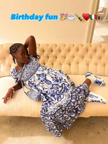 Madonna's daughter posing in a blue-and-white dress