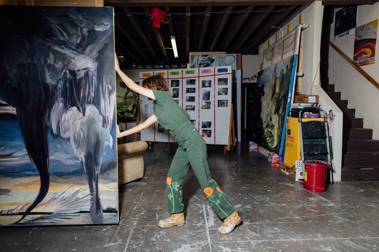 Emma pushing one of her enormous paintings across the studio