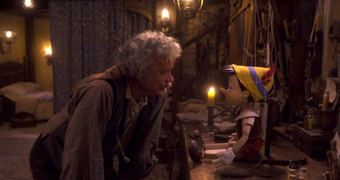 A woodcarver Geppetto talks to a wooden puppet named Pinocchio