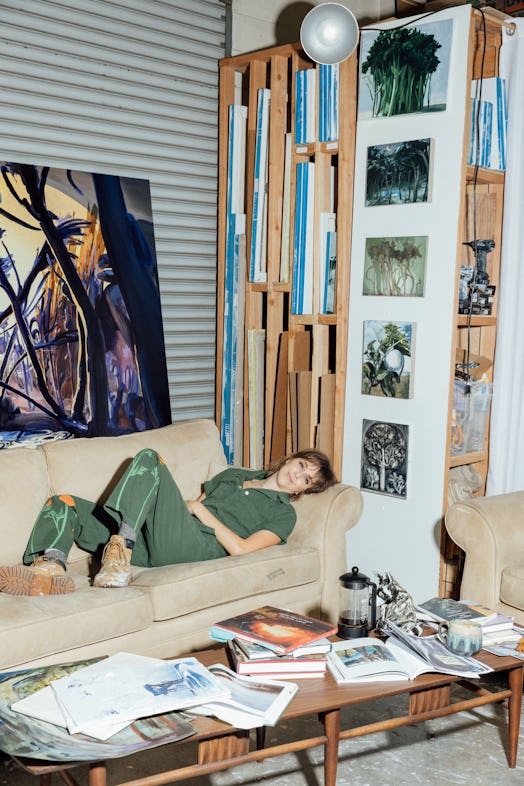 Emma laying on a couch in her studio in Los Angeles