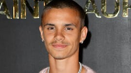 Romeo Beckham wears a pastel pink shirt ahead of dyeing his hair pastel pink.