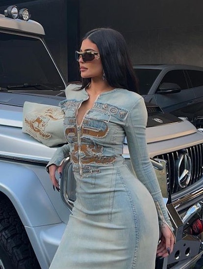 Who made Kylie Jenner's print handbag, blue ripped jeans, and