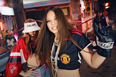 Jennie wearing a Manchester United crop top with pearls in Blackpink's 'Pink Venom' music video