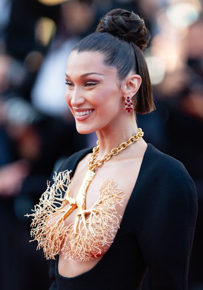 Bella Hadid's tattoo collection features three tiny dots on her chest.