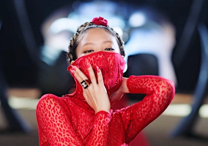 Jennie wearing bright red Alaïa that obscures her mouth in Blackpink's 'Pink Venom' music video