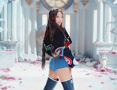 Jennie wearing a patch-covered jacket and teeny jean shorts in Blackpink's 'Pink Venom' music video