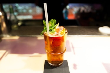 Photo of Pimm's Cup with straw and garnish set on bar ready to drink