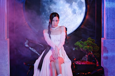 Jisoo wearing a long-sleeved white dress in Blackpink's 'Pink Venom' music video