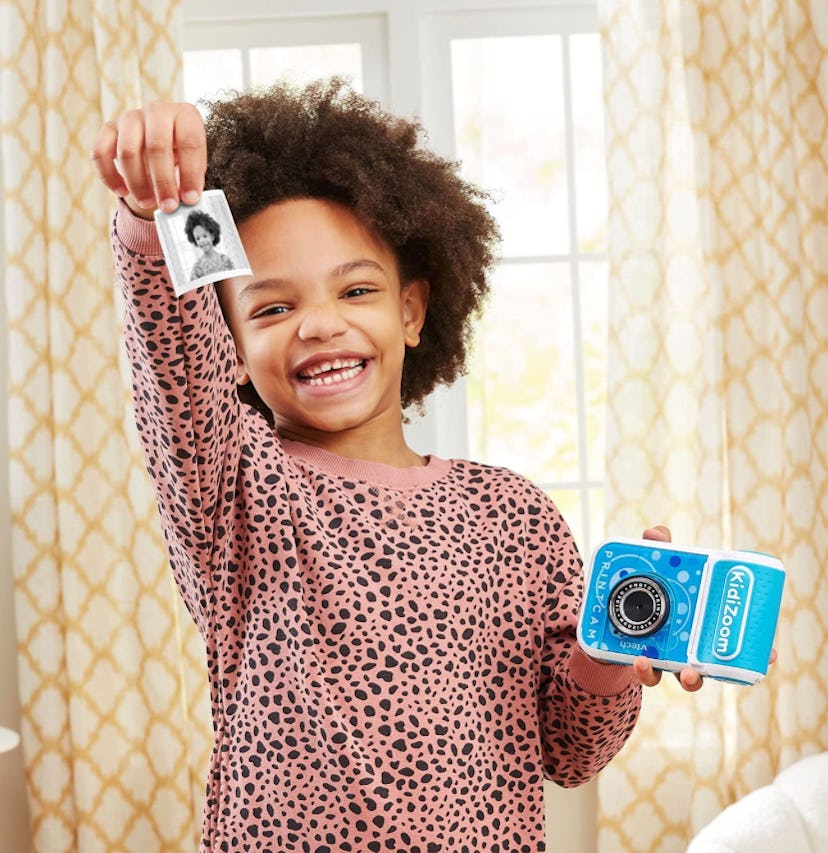 Little girl holding a VTech KidiZoom PrintCam in Blue