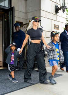 Kim Kardashian walking out of a hotel wearing cargo pants 