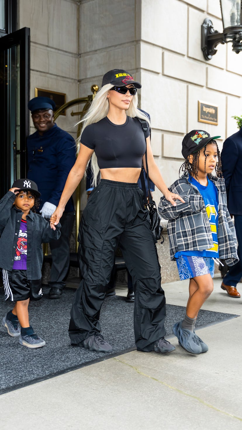 Kim Kardashian walking out of a hotel wearing cargo pants