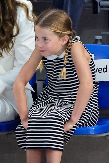 Princess Charlotte wearing a striped dress and slouching 