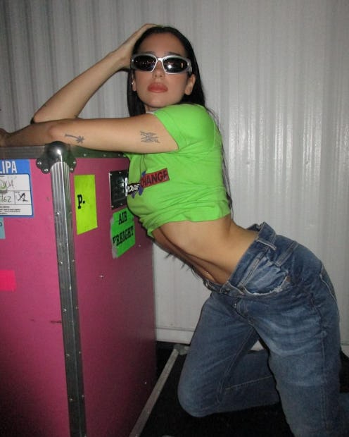 dua lipa wears green crop top and silver metallic wraparound sunglasses