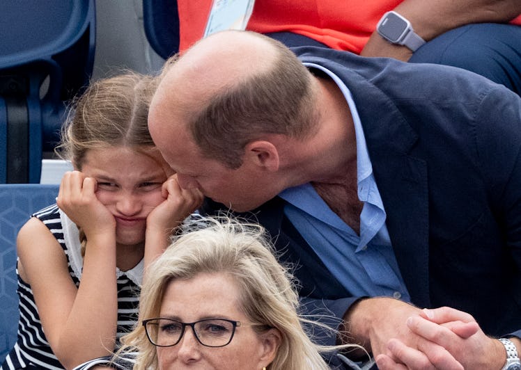 Prince William looking at a pouting Princess Charlotte