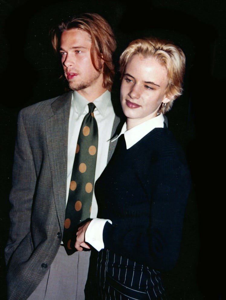 Brad Pitt wearing a polka-dot tie posing with then girlfriend Juliette Lewis