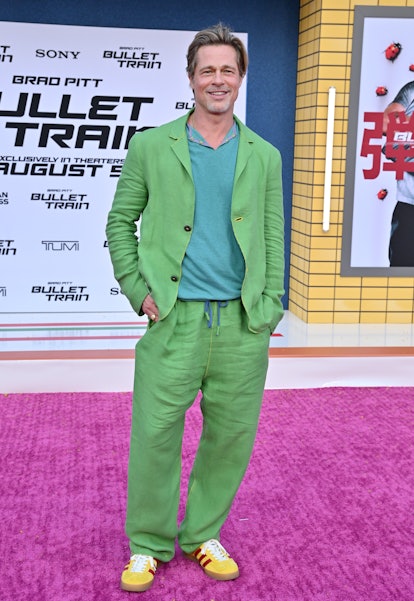 Brad Pitt wearing a blue shirt, lime green suit, and yellow sneakers