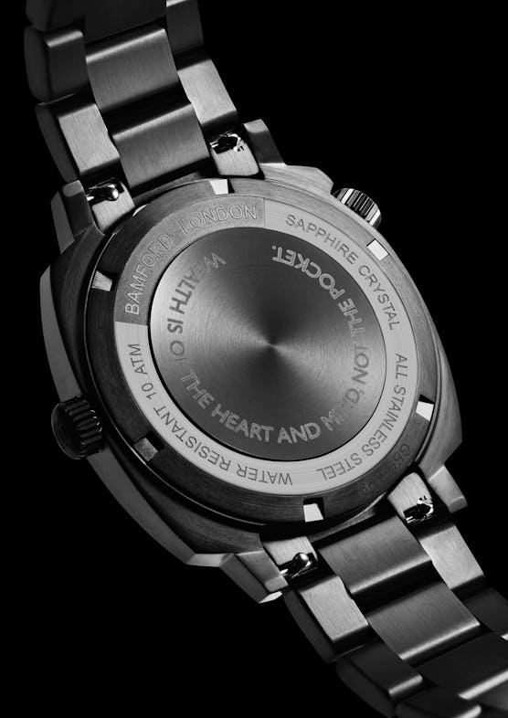 The back of the Billionaire Boys’ Club x Bamford London watch saying "wealth is of the heart and min...