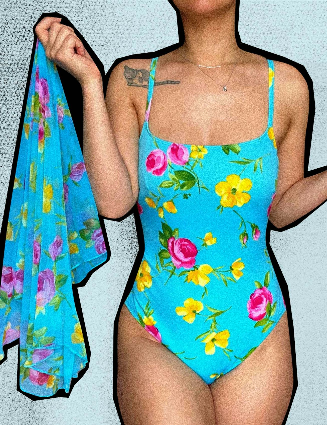 A girl with a tattoo on her right shoulder in vintage swimwear, a blue one-piece with a flower patte...