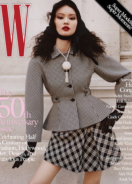 He Cong in a checkered coat and skirt with black gloves on the cover of W Magazine's 50th anniversar...