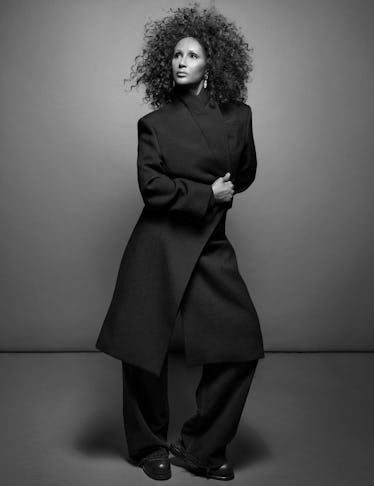 Iman in Alexander McQueen coat; Balenciaga jeans; Cartier earrings; Martine Rose shoes.