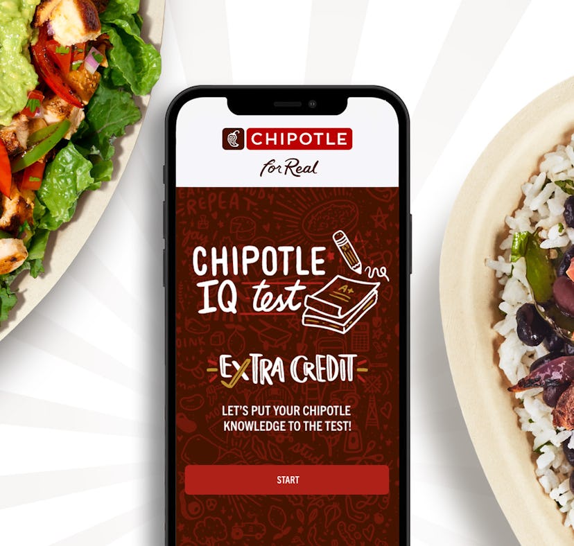 iPhone on a dining table with the Chipotle app opened, in the middle of two Chipotle dishes.