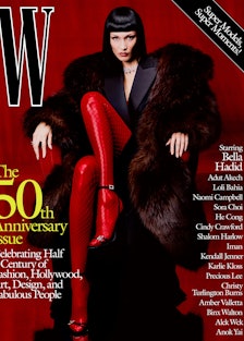 Bella Hadid wears a Saint Laurent by Anthony Vaccarello coat, tuxedo dress, and sandals; Araks bra; ...