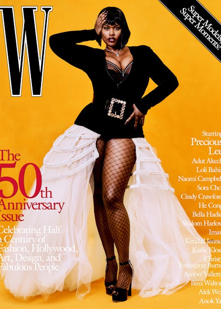 Precious Lee in a black top with a huge belt, white skirt, and fishnets on the cover of W Magazine's...