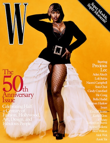 Precious Lee in a black top with a huge belt, white skirt, and fishnets on the cover of W Magazine's...