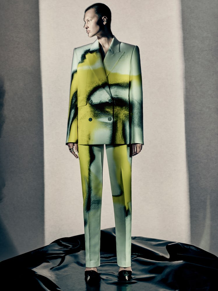 A model wearing a chartreuse and blue suit by Alexander McQueen