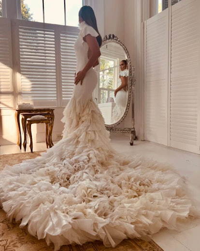 Jennifer Lopez in her first Ralph Lauren wedding dress, complete with a hand-tailored ruffled train.