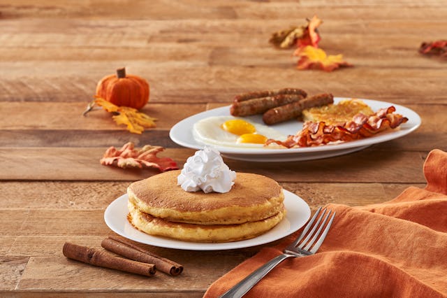 Pumpkin Spice Pancakes with cream on the top served on the table