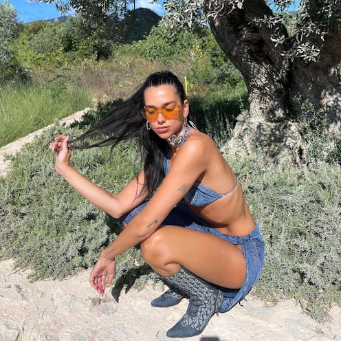 dua lipa wearing a denim bikini and boots from dior's spring 2000 collection 