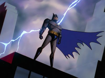 Batman standing on a rooftop with lightning behind him in Batman: Caped Crusader