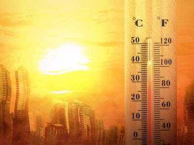 Thermostat rising to high temperature against sun and melting city backdrop