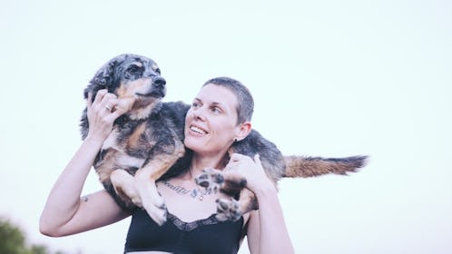 Picture of Tracey Anne Duncan with their dog, Stevie, resting on their shoulders