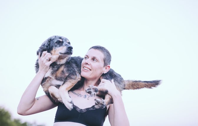 Picture of Tracey Anne Duncan with their dog, Stevie, resting on their shoulders