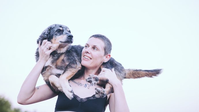 Picture of Tracey Anne Duncan with their dog, Stevie, resting on their shoulders