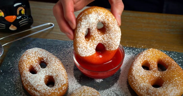 A baker shows how to make scary ghost doughnuts from TikTok with raspberry dipping sauce. 